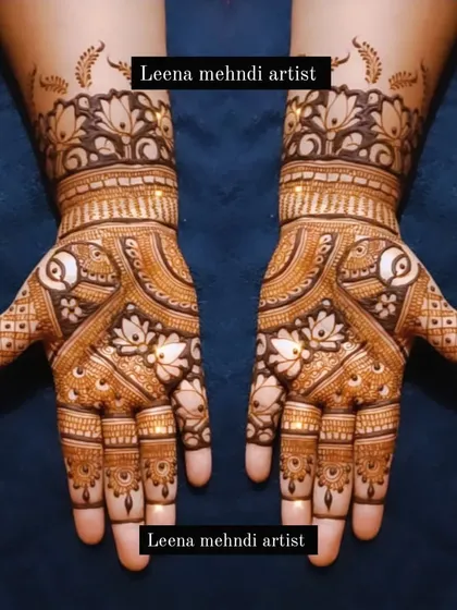 This design combines the grace of paisleys with the beauty of lotus flowers. The use of negative space around the main motifs makes them stand out, creating a sophisticated bridal look.