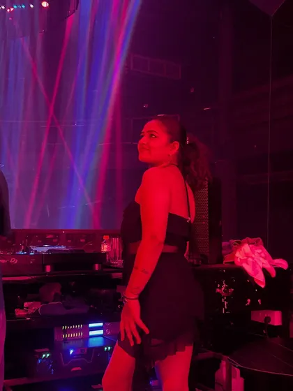 A candid shot of me by the console, enjoying the red-lit ambiance of the club.