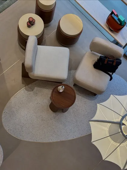 An overhead view of the lounge area at Entisi, showing how we used custom flooring to demarcate zones. The terrazzo-style tile with brass inlay creates a visual 'rug' for the seating arrangement, adding a layer of detail to the minimal design.