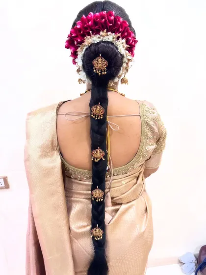 A bridal look is incomplete without the perfect hairstyle. This traditional South Indian braid, adorned with fresh flowers and intricate hair accessories, is a testament to the detailed hairstyling I provide as part of my complete bridal package.