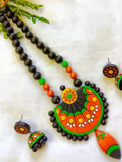 The same fan-shaped pendant necklace, in a bright and festive combination of green and orange.