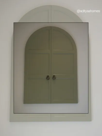 We also create unique, minimalist storage solutions. This sage green arched cabinet is a perfect example of a piece that is both a functional wardrobe and a work of art.