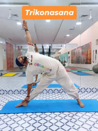 Here I am in Trikonasana (Triangle Pose). This fundamental standing pose stretches the hips, spine, and legs while strengthening the core and improving balance.