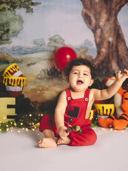 The pure joy of a first birthday! This little one is having a blast in his Winnie the Pooh themed photoshoot.