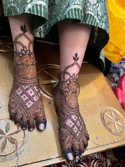 A classic bridal foot design with geometric patterns and a floral ankle cuff.