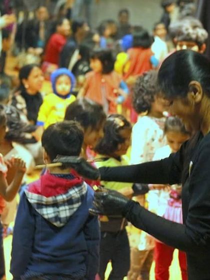 A team member helps a child interact with a sock puppet. These simple moments of play and connection are so important.