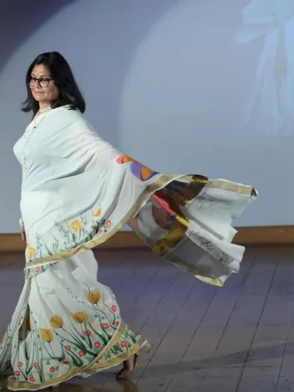 Walking the ramp in my hand-painted saree. The theme, "Har Nari, Krantikari" (Every Woman is a Revolutionary), is painted on the pallu, celebrating the power of women.