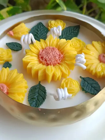 Another angle of the sunflower urli candle, showing the detailed petal work.