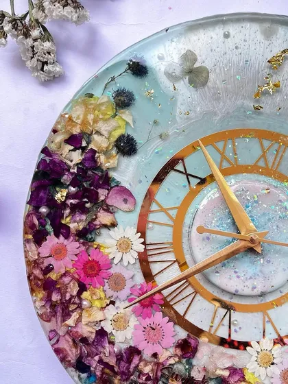 A close-up view of the colorful daisy clock, showing the intricate details of each preserved flower.