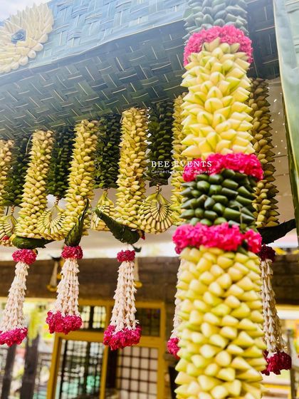 The beauty of traditional decor is in the details. Here you can see 'thomala' hangings made from woven leaves and fresh flowers, a classic element we teach you to create.