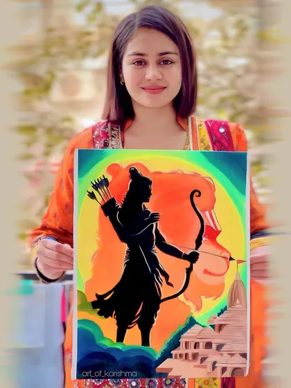 Holding my silhouette painting of Lord Ram against the backdrop of the Ram Mandir.