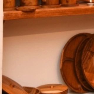 This shelf displays my handcrafted teak plates and bowls. The rich color and beautiful grain of the wood turn every meal into a special occasion.