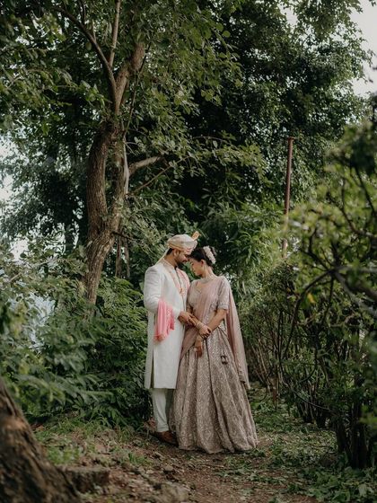Lost in a world of their own, surrounded by lush greenery. This wide shot creates a feeling of intimacy and seclusion, as if they are the only two people in the world.