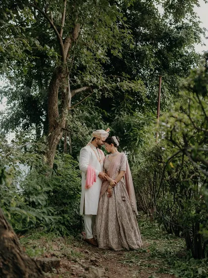 A romantic walk in the woods. This pre-wedding photo uses the natural landscape to frame the couple, creating a sense of a private, magical world just for them.