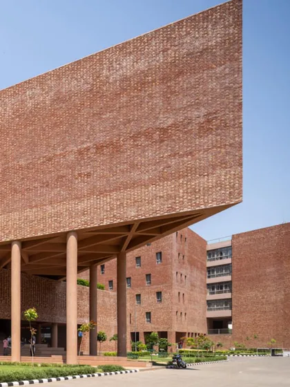 We celebrate monumental institutional architecture that shapes communities. This striking multi-utility building at Chandigarh University by Charged Voids uses a massive cantilevered brick volume to create a powerful architectural statement on campus.