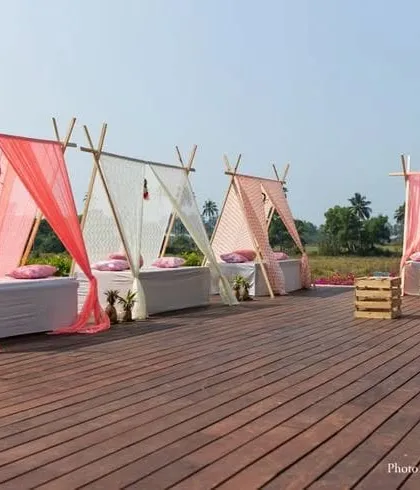 I also offer modern and chic decor options, like these teepee-style cabanas for a daytime event. This relaxed seating arrangement is perfect for a casual Mehendi or a beachside function, using light fabrics and comfortable cushions.