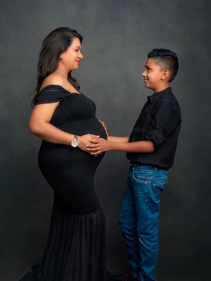 A heartwarming photo of a mom-to-be and her son, sharing a special moment before the new baby arrives.