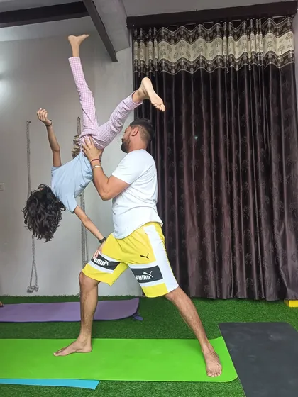 A playful lift in acro yoga. This is a moment of pure fun and freedom, showing the lighter side of the practice.