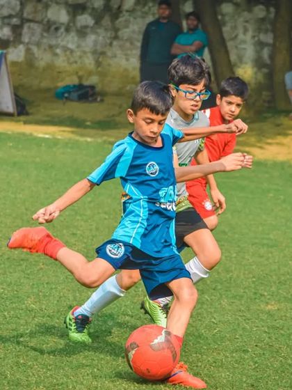 A young player takes a shot with his left foot, demonstrating his versatility.