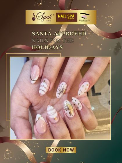 An elegant and festive nail set featuring a mix of white and gold designs. This look includes delicate stripes, polka dots, and snowflake accents for a sophisticated holiday manicure.