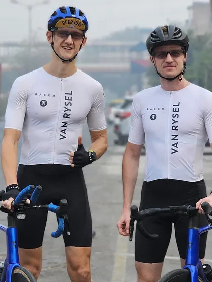 Two members in matching Van Rysel kits, showing team spirit on the road.