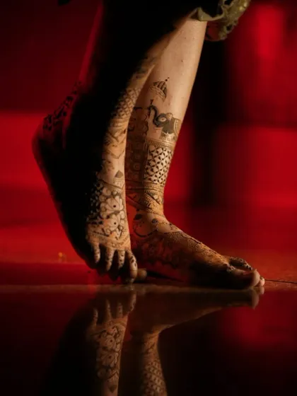 Another artistic shot of bridal feet with a dark stain, showing the reflection and the beautiful details.