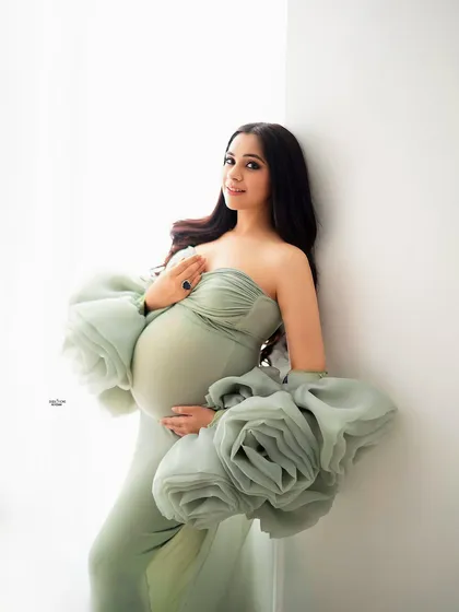 This is what I call the ultimate mamma glow. This portrait, shot in my New Delhi studio, uses soft natural light to highlight the beautiful baby bump in this elegant mint green couture gown with dramatic floral sleeves.