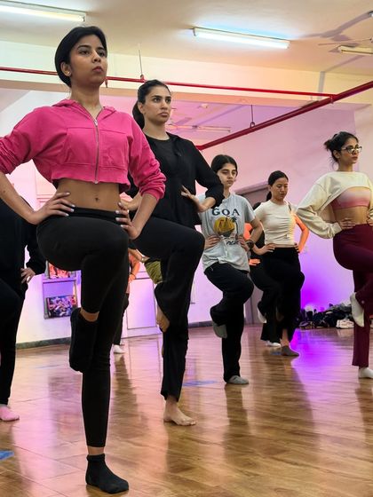 Students practicing a balancing exercise during our warm-up. Building a strong foundation with proper technique is an important part of every class.