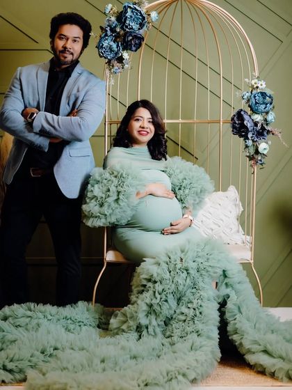 A lovely portrait of the couple from the family maternity session. The dad-to-be stands proudly next to his wife, who is seated and glowing in her beautiful gown.