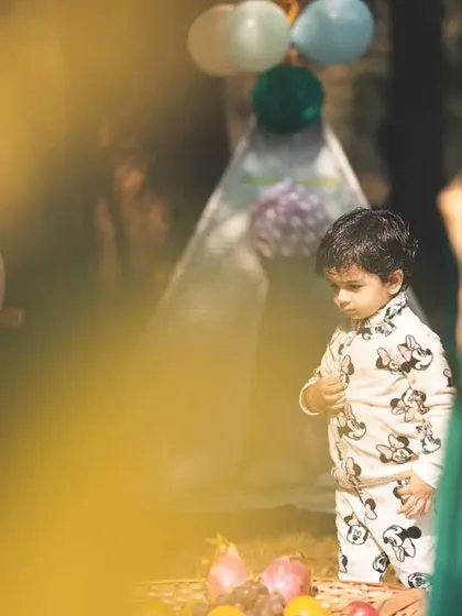 A candid shot of a little boy at his outdoor party. I often shoot through foreground elements to create a dreamy, intimate feel that draws you into the moment.