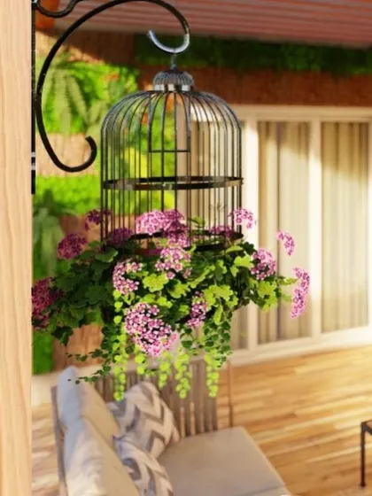 Small details can make a big difference. Here, a hanging birdcage planter with cascading pink flowers adds a touch of charm and color to the balcony, making it feel more like a garden.