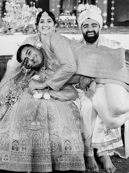 A hilarious, unposed moment with a friend crashing the couple's portrait. These are the funny, unexpected memories that make a wedding unique.