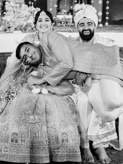 A hilarious, unposed moment with a friend crashing the couple's portrait. These are the funny, unexpected memories that make a wedding unique.