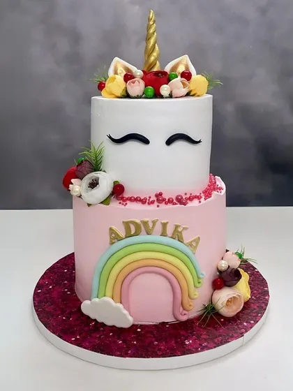 Another angle of this beautiful unicorn and rainbow fondant cake, showing the glittery cake board and detailed decorations.