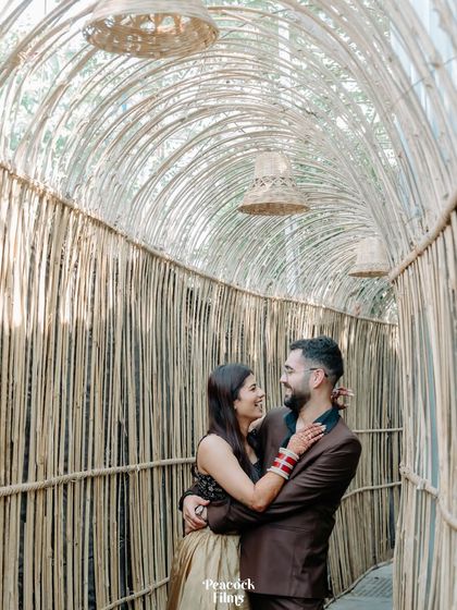 A happy, romantic portrait of the couple inside the bamboo tunnel. Their smiles and embrace capture the love and joy of their celebration.