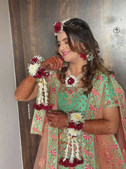 Blooming in colors for her Haldi. This bride's look is a perfect blend of vibrance and elegance, with fresh floral jewelry and makeup that complements every petal.