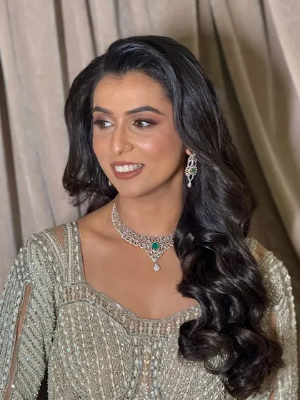 A close-up of the final reception makeup. The look is sophisticated, with beautifully contoured features and a warm, inviting color palette.