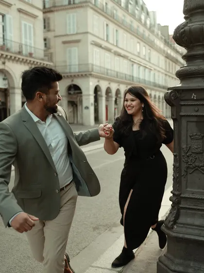 A playful chase through the charming streets of Paris. This candid shot is full of life and laughter, capturing an unposed, authentic moment from Varun and Aishwarya's pre-wedding shoot.