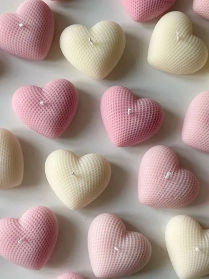 A collection of my waffle-textured heart-shaped candles in soft pink and cream colors. These are perfect as romantic gifts, wedding favors, or simply to add a touch of love to your home decor.