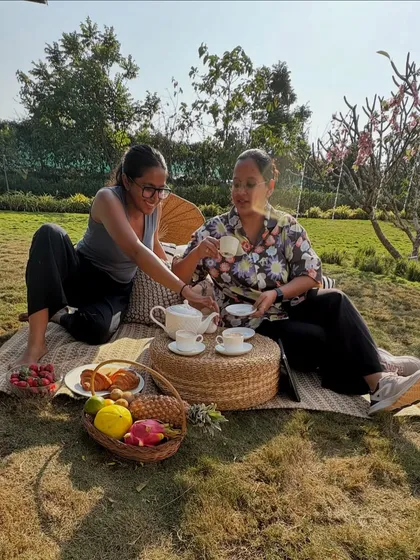 Even the crew gets to test the setup. This candid moment from a lifestyle shoot shows my team members enjoying the picnic scene we created, a fun part of the process that ensures everything looks authentic and inviting.