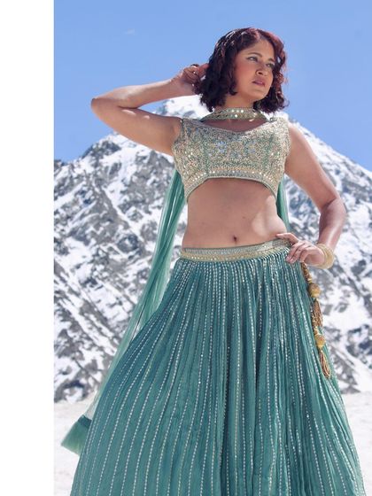 This shot highlights the flow of the lehenga skirt.