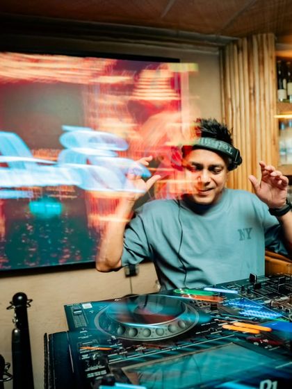 A long-exposure shot capturing the motion and energy behind the decks at Bastian's Sip Club.