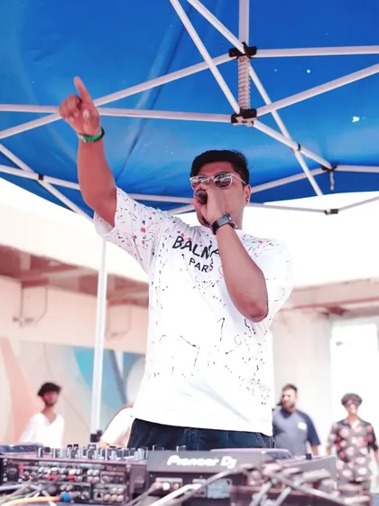 Commanding the stage and hyping the crowd on the mic during a Holi 2024 event. Daytime parties have a unique and vibrant energy.