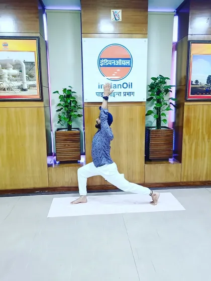 Demonstrating a high lunge (Alanasana) during the corporate event at IOCL Ashok Nagar.