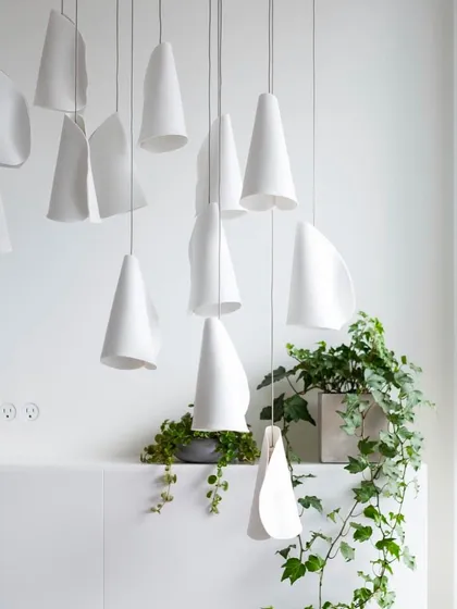The Bocci 21 pendants in their unlit state, showcasing their pure white, sculptural forms against a clean backdrop. They function as art objects even when turned off.