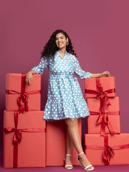 Posing with a stack of gifts for a Fable Street sale campaign. This kind of commercial modeling is key for driving holiday sales and creating a festive brand atmosphere.