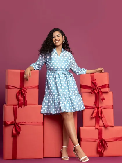 Surrounded by presents in a cute polka dot dress. This was such a fun shoot to be a part of.