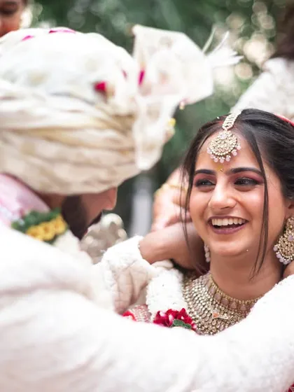 A happy moment during the wedding rituals, full of smiles.