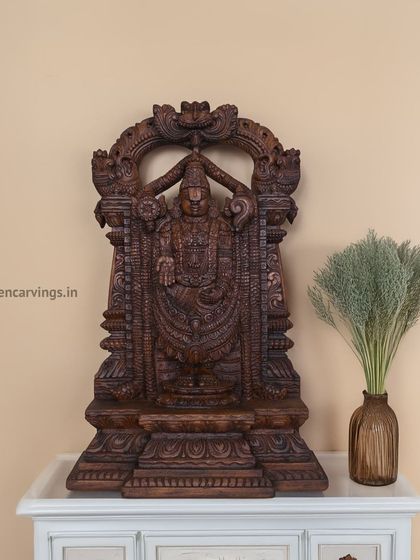 A beautifully carved Balaji statue with a dark brown finish, placed on a console table to show its suitability for interior decoration. This piece combines spiritual significance with aesthetic elegance.