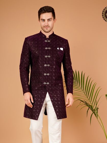 This deep purple sherwani is a perfect example of my commitment to ethnic wear for your special day. The rich color and detailed fabric make it a truly royal choice.
